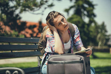 Young woman is going on vacation. She is waiting for her transportation.
