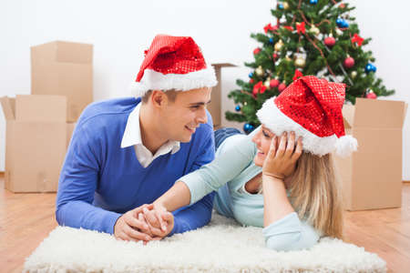 Happy couple is celebrating Christmas in their new home.の写真素材