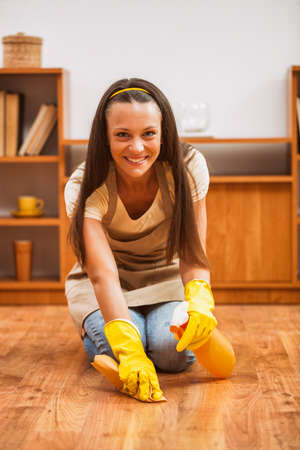 Young happy woman is cleaning the house.の写真素材