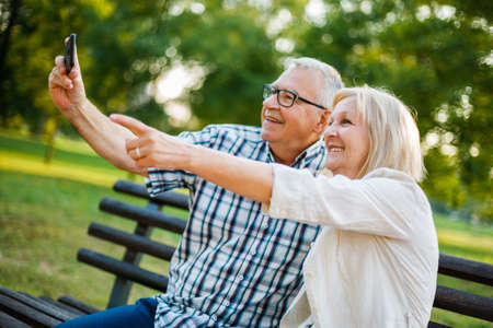 Happy senior couple is having fun in park.