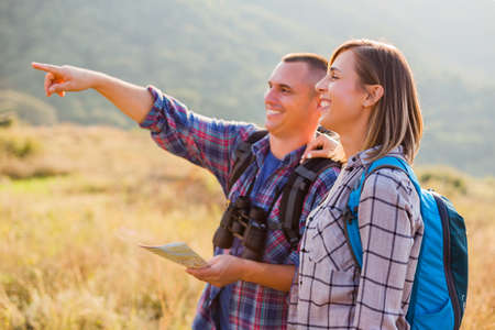 Happy couple is hiking in mountain.の写真素材