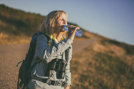 Senior woman is hiking in mountain. Active retirement.の写真素材