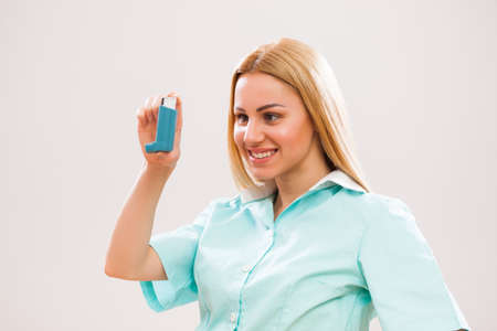 Portrait of young doctor who is holding inhaler.の写真素材