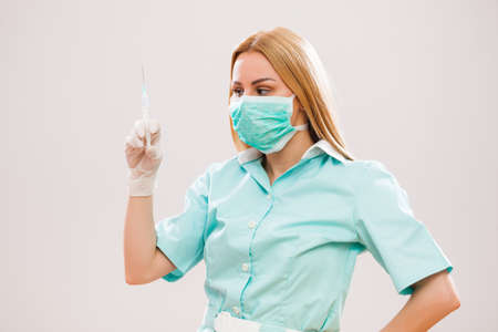 Portrait of young nurse who is holding syringe.の写真素材