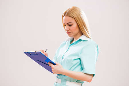Portrait of young doctor who is writing prescription.の写真素材