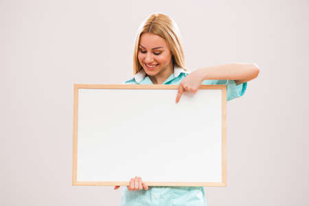 Portrait of young nurse who is holding whiteboard.の写真素材