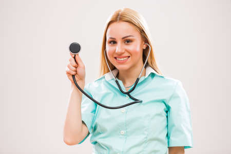 Portrait of young nurse who is holding stethoscope.の写真素材