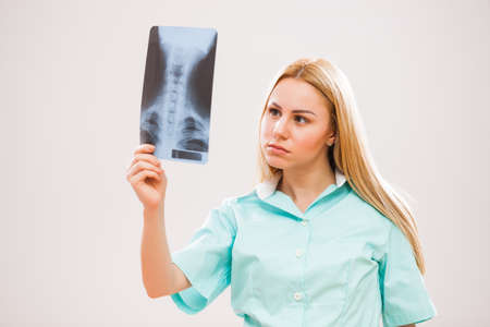 Portrait of young doctor who is looking at x-ray image.の写真素材