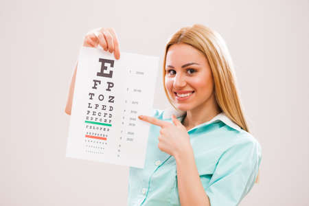 Portrait of young doctor who is holding eye examination test.の写真素材
