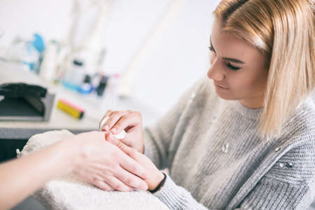 Manicure process at professional saloon. Nail treatment.の写真素材