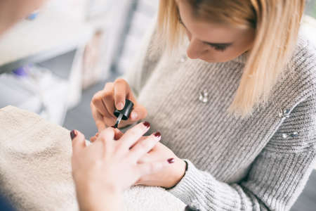Manicure process at professional saloon. Nail treatment.の写真素材