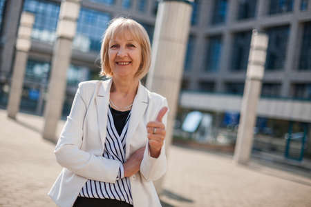 Outdoor portrait of happy senior businesswomanの写真素材