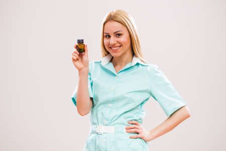 Portrait of young nurse who is holding pills.の写真素材