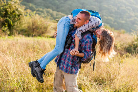 Happy couple is hiking in mountain.の写真素材