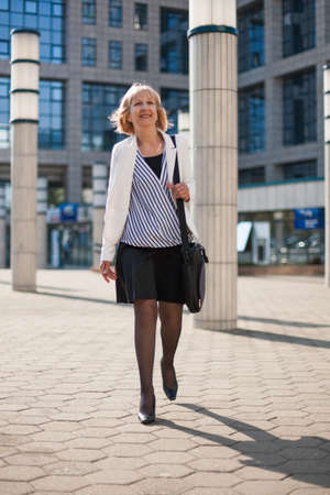 Senior businesswoman is in hurry.の写真素材