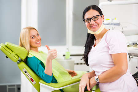Happy young woman at dentist.の写真素材