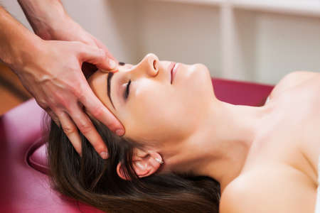 Young woman is enjoying massage on spa treatment.の写真素材
