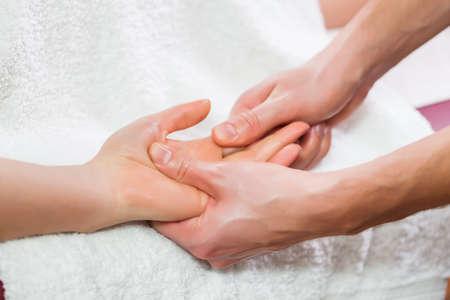 Young woman is enjoying massage on spa treatment.の写真素材