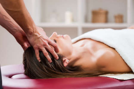 Young woman is enjoying massage on spa treatment.の写真素材