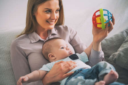 Happy mother and her baby boy at home.