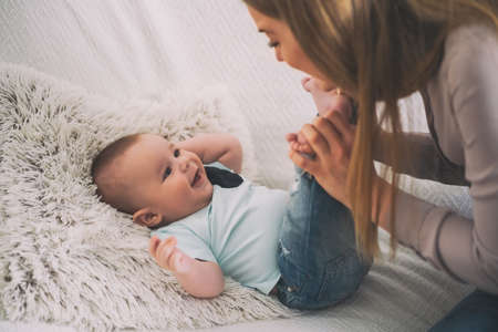 Happy mother and her baby boy at home.の写真素材