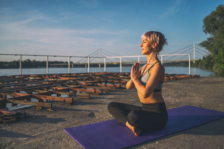 Woman practicing yoga on sunny day. Padmasana, Lotus pose.の写真素材