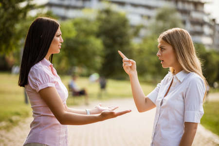 Business colleagues are arguing in park on break.