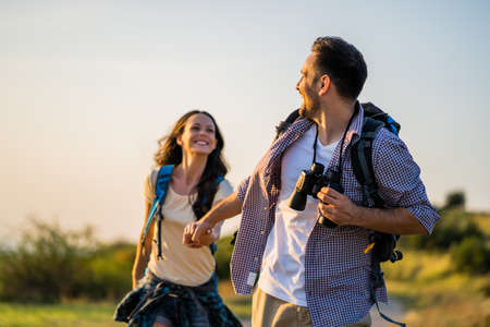 Happy couple is hiking in mountain.の写真素材
