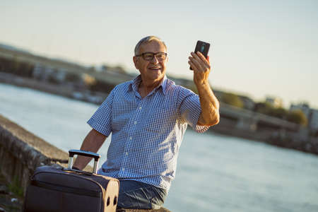 Outdoor portrait of senior man who is traveling.