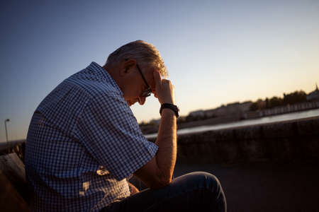 Outdoor portrait of worried and depressed senior man.の写真素材