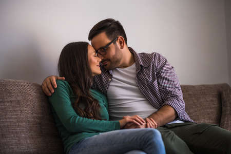 Happy couple is relaxing at home.