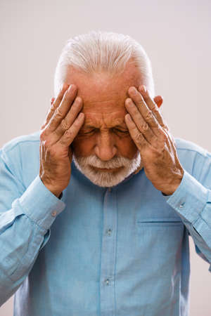 Portrait of senior man who is having headache.の写真素材
