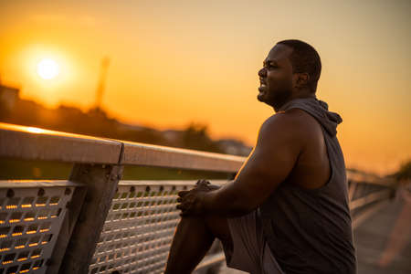Portrait of young cheerful african-american man in sports clothing who is looking away.の写真素材
