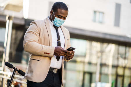 Portrait of responsible businessman who is wearing protective mask. Covid-19 virus pandemic concept.の写真素材