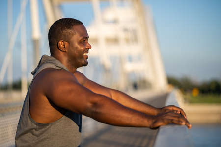 Portrait of young cheerful african-american man in sports clothing who is ready for workout.