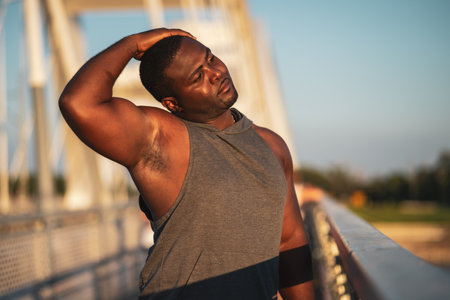 Portrait of young african-american man in sports clothing who is exercising to reduce his body weight.の写真素材