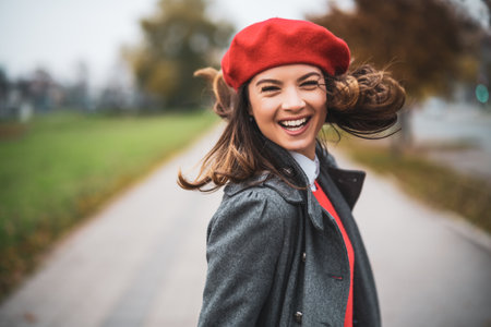 Happy woman walking on the street and smiling.の写真素材