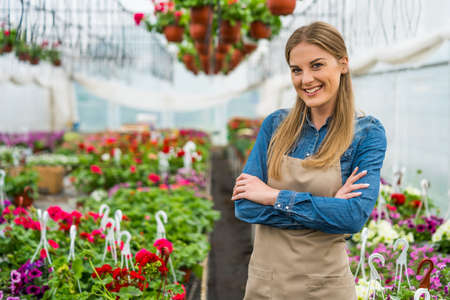 Woman is owning small business greenhouse store. Female entrepreneur.の写真素材