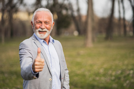 Outdoor portrait of cheerful senior businessman.の写真素材