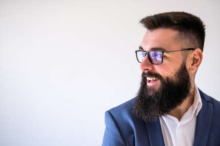 Portrait of happy businessman who is looking away and smiling. Copy space on image for your text or advert.の写真素材