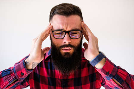 Portrait of man who is tired and having headache. Copy space on image for your text or advert.の写真素材