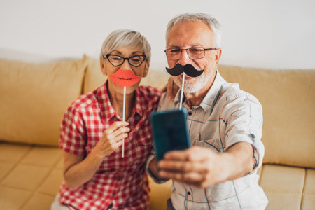 Happy mature couple is having fun at home.