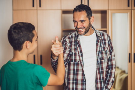 Portrait of happy father and son at home.の写真素材