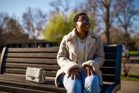 Outdoor close up portrait of happy black woman. She is enjoying sun and fresh air.の写真素材