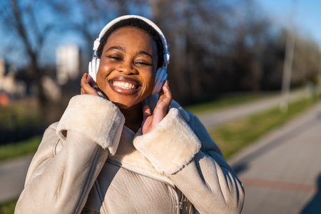 Outdoor portrait of happy black woman on sunny day.の写真素材