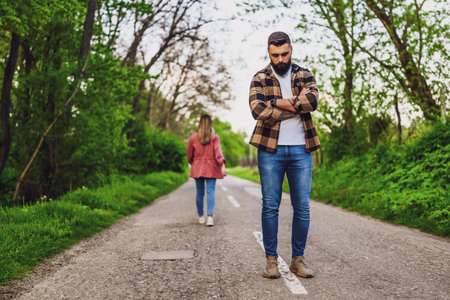 Couple is having difficulties in their relationship. Woman is leaving her man after argue. Conceptual image.の写真素材