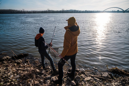 Father and son are ready for fishing on winter day. Freshwater fishing.の写真素材
