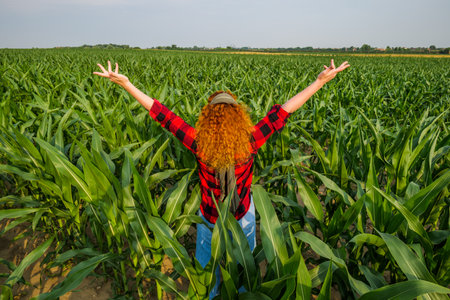Portrait of cheerful female farmer who is cultivating corn. Agricultural occupation.の写真素材
