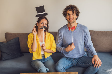Portrait of young happy couple at home. They are having fun.の写真素材