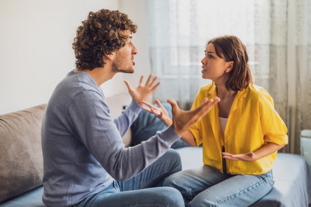 Man and woman are sitting at sofa and arguing. Relationship problems.の写真素材